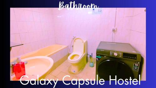 a bathroom with a toilet and a sink and a tub at The Galaxy Star Capsule Near Burjuman Metro Station in Dubai