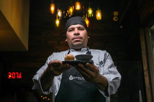 a man holding a plate of food in his hands at Hotel Termales del Ruiz in Manizales