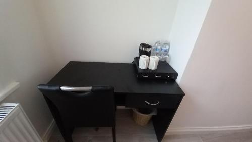 a black desk in a room with a black chair at Home Away From Home,, in Kent