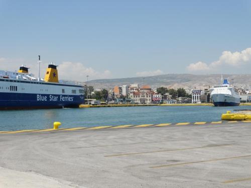 a large blue and white ship in the water at Faros I in Piraeus