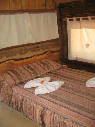 Casa GrandeにあるSENCILLAMENTE CABAÑASのタオルが敷かれたベッドのある寝室