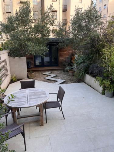 a patio with a table and chairs and a building at Kemp Town apartment in Brighton & Hove