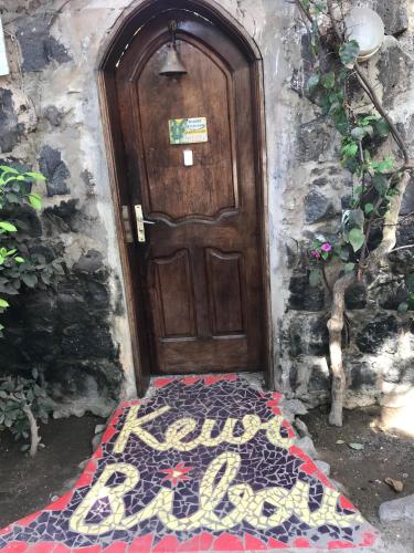 a wooden door with a welcome mat in front of it at Fabuleux Studio Petit Marrakech in Dakar