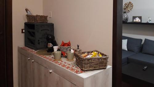 a counter with baskets of food and a television at Casa 4 Archi in Lentini