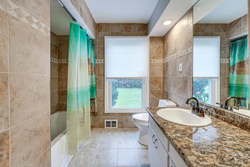 a bathroom with a sink and a toilet and a tub at Family-Friendly Bloomfield Hills Home with Patio! in Bloomfield Hills