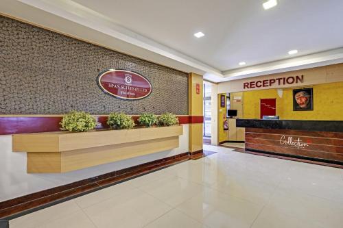 a lobby of a hotel with a reception counter at Collection O Sri Sai Ram Suites in Bangalore
