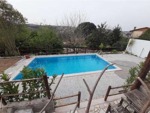 a large blue swimming pool with chairs in a yard at Casa Do Tapado in Amarante