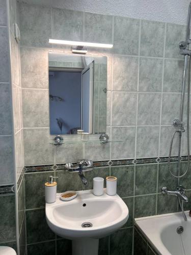 a bathroom with a sink and a mirror at Pirostka Vintage Room in Sofia