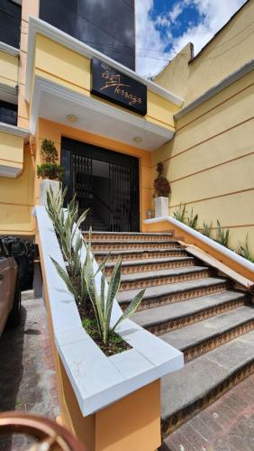 a building with stairs in front of a building at la terraza departamentos 301 in Cuenca