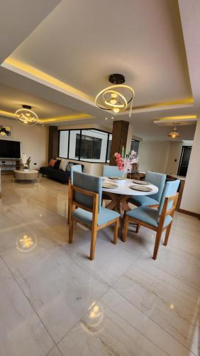 a living room with a table and chairs and a couch at la terraza departamentos 301 in Cuenca