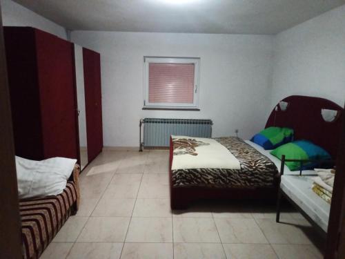 a bedroom with two beds and a window in it at Apartman SM IK in Tomislavgrad