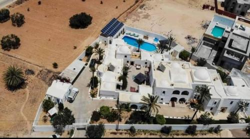 an aerial view of a large white house with palm trees at Maison Leila chambres d hotes in Midoun