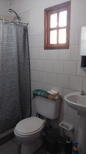 a bathroom with a toilet and a sink at Banim in El Hoyo