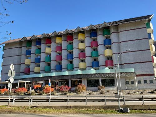 a large building with colorful containers on it at Hotel Liberty Self Check-In in Bellinzona