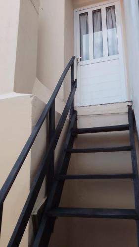 una escalera que conduce a una puerta blanca con una ventana en VILLA LIDIA PLANTA ALTA en Mar del Plata