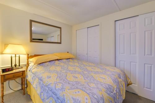 a bedroom with a bed and a mirror and a table at Quaint Lakemont Retreat 1 Mi to Seneca Lake! in Lakemont