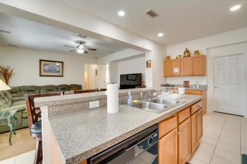 a kitchen with a sink and a living room at 22 Mi to Disney Kissimmee Home with Pool and Hot Tub in Kissimmee