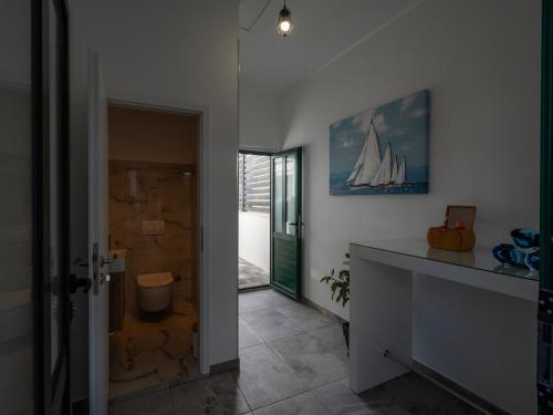 a bathroom with a shower with a sailboat on the wall at Adam apartments in Stobreč