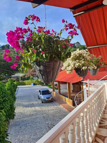 a small car parked on a street with flowers at Cabañas Amalú in San Agustín