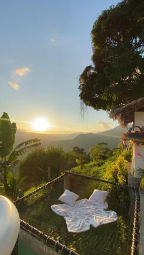 a view from a house with the sun in the background at Andino Glamping in La Peña