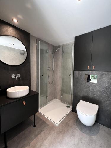 a bathroom with a shower and a toilet and a sink at Glamping Špindl One&Only in Špindlerův Mlýn