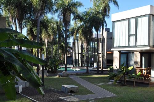 a house with palm trees in front of it at El Cairel 2 in Paso de la Patria