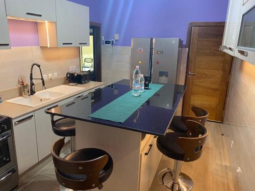 a kitchen with a counter with a bottle of water on it at THE LANDING LODGE-ABIDJAN in Abidjan