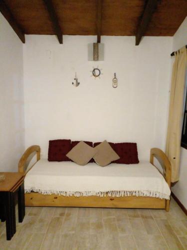 una camera da letto con un letto con cuscini sopra di La Gitana - Casa en La Paloma a La Paloma