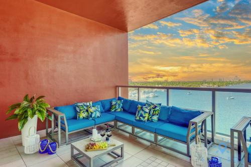 a living room with a blue couch and a view of the ocean at Costa Hollywood Beach in Hollywood