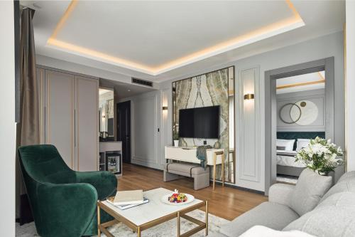 a living room with a couch and a room with a bed at La Fleur Boutique Hotel in Tivat