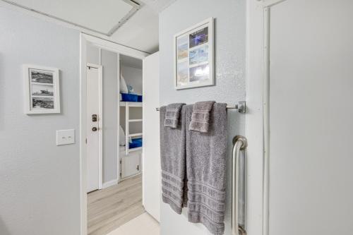 a bathroom with a towel hanging on a door at Corpus Christi Condo Pool and Access to North Beach in Corpus Christi