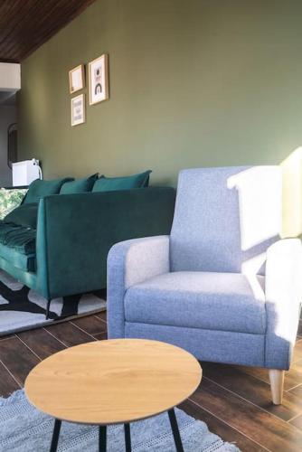 a living room with a blue couch and a table at Valtesiniko View in Valtessiniko 