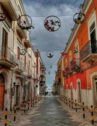 a city street with buildings and a clock hanging over it at Casa Tramontana in Manfredonia