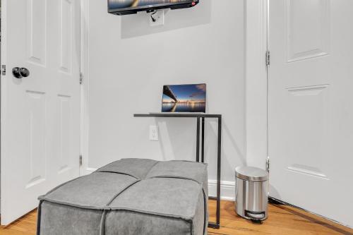 a room with a ottoman in front of two doors at Fairmount Oasis 1BR Haven in Philadelphia