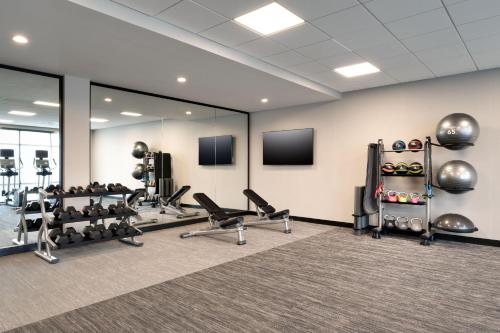 a fitness room with cardio equipment and mirrors at TownePlace Suites by Marriott Show Low in Show Low