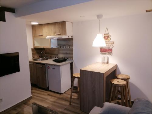 a small kitchen with a table and a counter top at A Bre Da Bre Family Club in Niš
