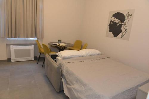 a room with a bed and a table in a room at Apartment Dora 3,beach apartment in Tivat