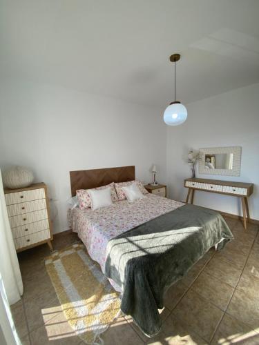 a bedroom with a bed and a mirror on the wall at La Casa del San Antón in Níjar