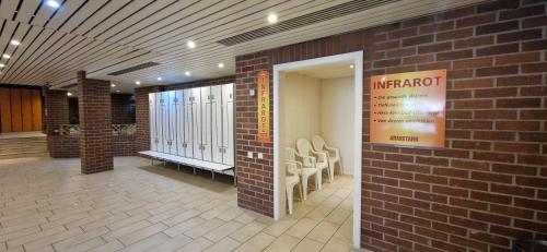 a lobby of a building with a brick wall at Sauna, Pool und Gartenzugang in Sankt Englmar