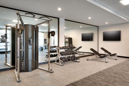 a gym with several tread machines and mirrors at Fairfield by Marriott Inn & Suites Show Low in Show Low