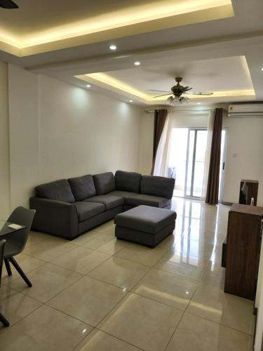 a living room with a couch and a table at Robert's Place Block A 202 in Baatsona