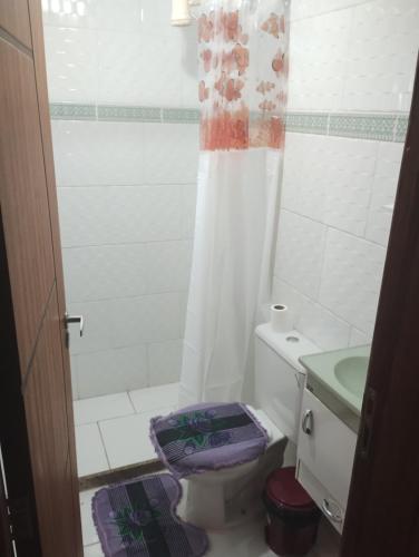 a bathroom with a toilet and a shower and a sink at Apartamento Mangaratiba 2 suites in Mangaratiba