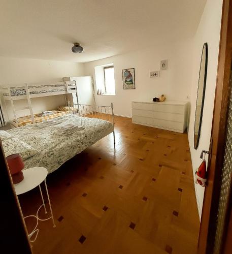 a bedroom with a bed and a wooden floor at B&B da Lule in Aosta
