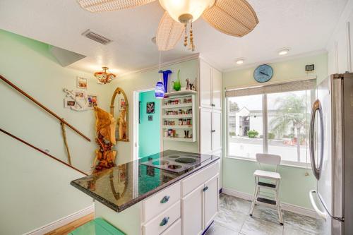 a kitchen with a counter and a fishtank on the wall at Riverfront Townhome in Titusville Community Pool in Titusville