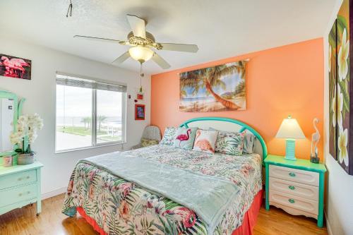 a bedroom with a bed with an orange wall at Riverfront Townhome in Titusville Community Pool in Titusville