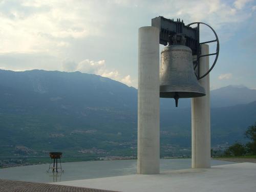 a bell sitting on top of a building with a table at Hotel Sant'Ilario in Rovereto