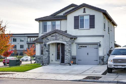 a white house with a car parked in front of it at Stylish Lodi Wine Country Retreat with Private Patio in Lodi