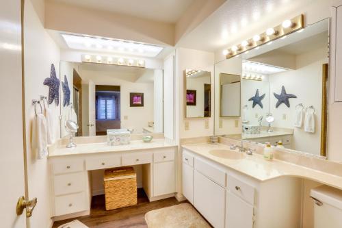 a bathroom with two sinks and a large mirror at Cathedral City Condo with Community Pools and Hot Tubs in Cathedral City
