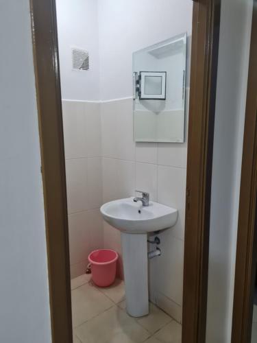 a bathroom with a sink and a mirror at appart hotel tanger gzenaya in Tangier