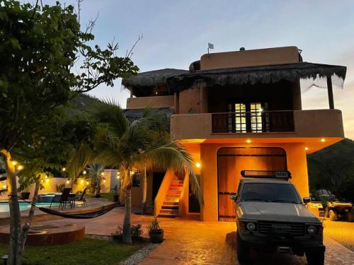 a white truck parked in front of a house at Private Home with Pool and Spa - Kayaks, Quad Rental in Las Palmas
